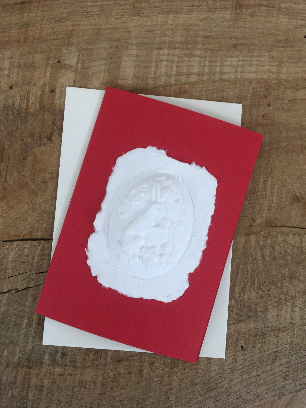 Paper relief card Easter bunny brings Easter eggs